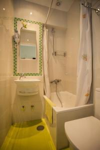 a bathroom with a sink and a toilet and a shower at AVA Rooms in Madrid
