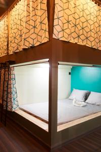 a bed in a loft bedded room with a window at Lost & Found Zanzibar in Zanzibar City