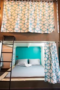 a bunk bed with a blue wall and a ladder at Lost & Found Zanzibar in Zanzibar City +18 photos