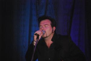 a man is singing into a microphone at Dolphin Hotel in Inishbofin