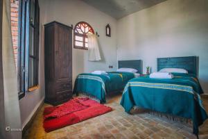 A bed or beds in a room at Dar Wadada
