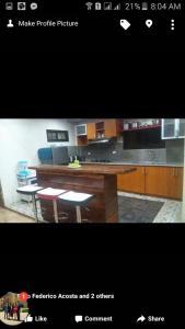 a picture of a kitchen with a counter and chairs at Affordable Baguio APT in Baguio