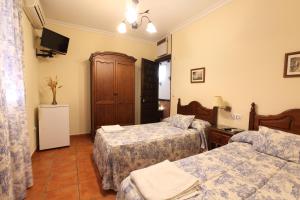 Ein Bett oder Betten in einem Zimmer der Unterkunft Hostal Rocio