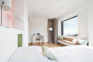 Postel nebo postele na pokoji v ubytování Hôtel des Patients