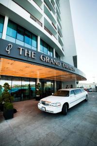 a white car parked in front of a grand taza building at The Grand Tarabya Hotel in Istanbul