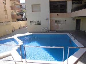 a large swimming pool in the middle of a building at COSTA DAURADA APARTAMENTS - Zurbaran in Salou