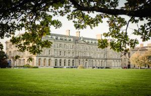 een groot gebouw met groen gras ervoor bij DCU Rooms All Hallows in Dublin
