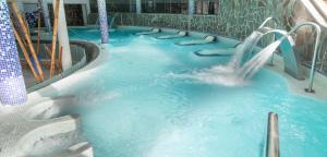 a water slide in a pool with blue water at Gloria Palace Royal Hotel & Spa in Puerto Rico de Gran Canaria