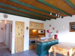 a kitchen with a table and a counter top at Chalanche in Barcelonnette