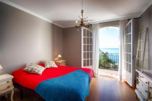 a bedroom with a bed and a large window at L'Encantarella in Roses