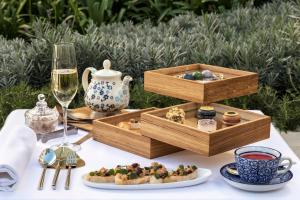 a table with a plate of food and a glass of wine at Palacio de los Duques Gran Meliá - The Leading Hotels of the World in Madrid