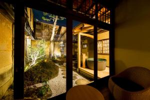 a view of a garden from the inside of a house at Nazuna Kyoto Nijo-jo in Kyoto