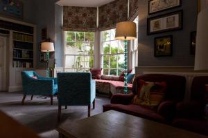 a living room with a couch and chairs and a window at Tickton Grange Hotel in Beverley