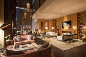 a living room with couches and chairs at The Fitzwilliam Hotel Belfast in Belfast