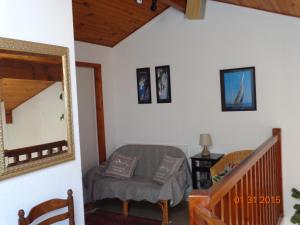 a living room with a mirror and a chair at Duplex en Hendaye in Hendaye