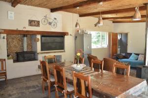 a living room with a wooden table and chairs at Bibi's Joy in Swellendam