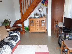 a living room with a couch and a wooden cabinet at Duplex en Hendaye in Hendaye