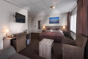 Rúm í herbergi á SEA YOU Hotel Noordwijk