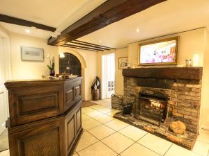 a living room with a fireplace and a television at Sheene Mill in Royston