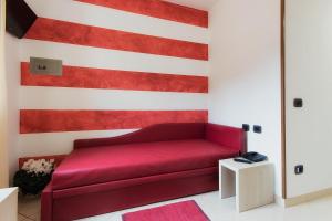 a red couch in front of a american flag wall at Albergo Ristorante San Matteo in San Bartolomeo al Mare