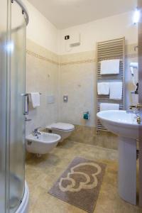 a bathroom with a sink and a toilet and a shower at Albergo Ristorante San Matteo in San Bartolomeo al Mare