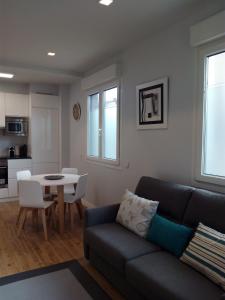 a living room with a couch and a table at Kantabriko Zarautz in Zarautz