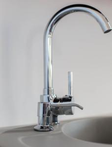 a kitchen sink with a chrome faucet at Noclegi Prestige in Nowy Sącz