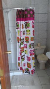 a shower curtain in a bathroom with a toilet at Cabaña Don Claudio in Osorno