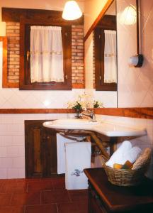 a kitchen with a sink and a basket of towels at Casa Rural La Riba in Sames +79 photos