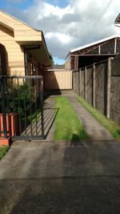 a fence in front of a house with a yard at Cabaña Don Claudio in Osorno