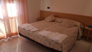 Postel nebo postele na pokoji v ubytování Hotel Patrizia