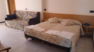 Postel nebo postele na pokoji v ubytování Hotel Patrizia