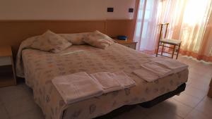 Postel nebo postele na pokoji v ubytování Hotel Patrizia