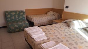 Postel nebo postele na pokoji v ubytování Hotel Patrizia