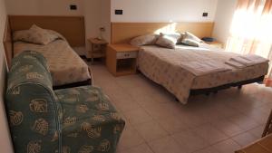 Postel nebo postele na pokoji v ubytování Hotel Patrizia