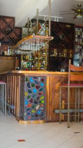 a bar with a bunch of wine bottles at Gingerbread Restaurant & Hotel in Nuevo Arenal