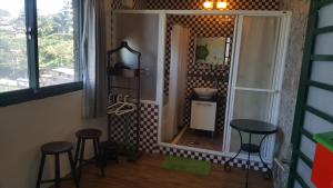 a bathroom with two stools and a large mirror at Jiufen Walk Inn 3x3 in Jiufen