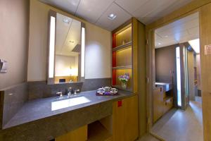 a bathroom with a sink and a large mirror at Wanchai 88 in Hong Kong