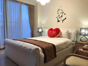 a bedroom with a heart pillow on a bed at Grand Allevia Villa in Wujie