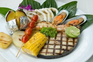 a plate of food with seafood and vegetables on it at Panviman Resort Koh Phangan - SHA Extra Plus in Thong Nai Pan Noi