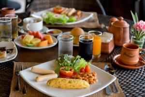 a plate of food on a table with plates of food at Panviman Resort Koh Phangan - SHA Extra Plus in Thong Nai Pan Noi