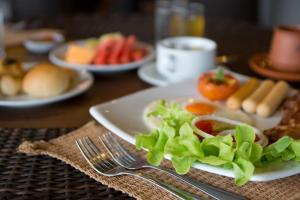 a plate of food with lettuce and tomatoes on a table at Panviman Resort Koh Phangan - SHA Extra Plus in Thong Nai Pan Noi