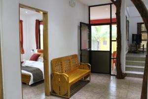 a bedroom with a mirror and a bench in a room at Alona's Coral Garden Resort (Adult-Only) in Panglao +142 photos