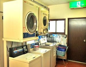 a kitchen with a washer and a washing machine at Rishiri Greenhill Inn in Oshidomari