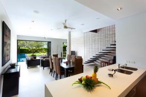 a kitchen and dining room with a table and chairs at Baan Yamu Private Villa in Ban Pa Khlok