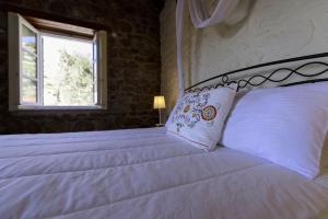 Säng eller sängar i ett rum på Nereids Guesthouse