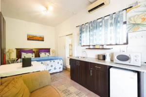 a kitchen and living room with a bed in a room at Villa Valencia in Pinetown +63 photos