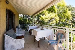 a patio with a table and chairs on a porch at Villa Valencia in Pinetown