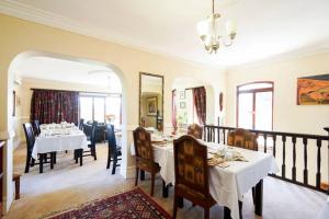 a dining room with a table and chairs and a dining room at Villa Valencia in Pinetown