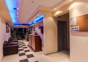 a lobby with a waiting room with blue lights at Calypso Beach Hotel in Paralia Katerinis
